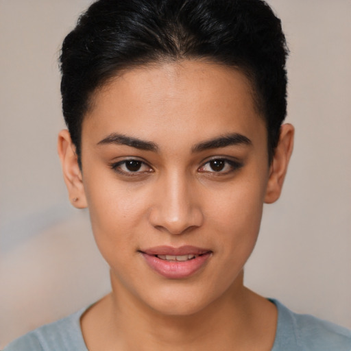 Joyful latino young-adult female with short  black hair and brown eyes