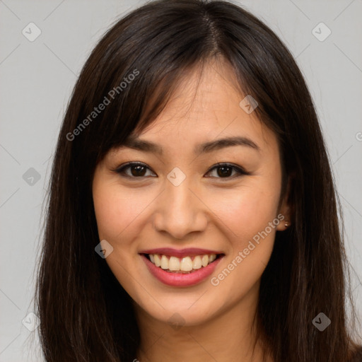 Joyful asian young-adult female with long  brown hair and brown eyes