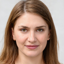 Joyful white young-adult female with long  brown hair and green eyes