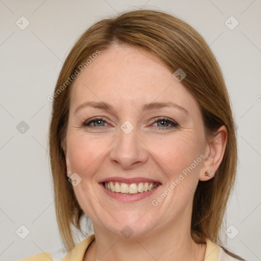 Joyful white adult female with medium  brown hair and blue eyes