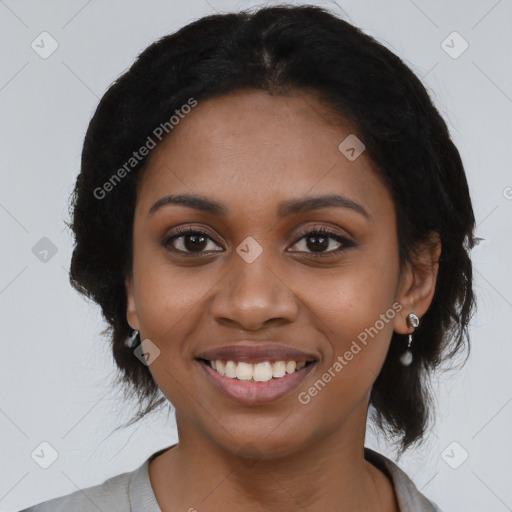 Joyful black young-adult female with long  black hair and brown eyes