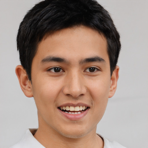 Joyful asian young-adult male with short  brown hair and brown eyes