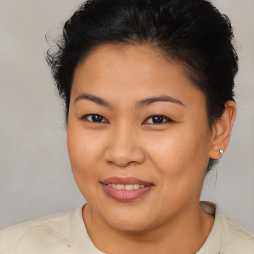 Joyful asian young-adult female with short  brown hair and brown eyes