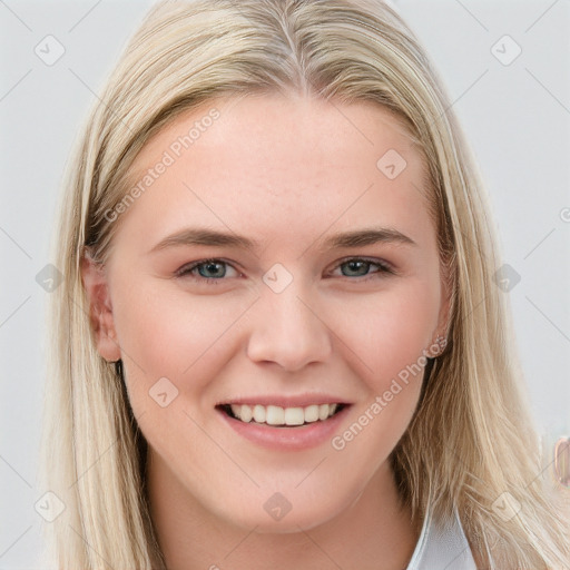 Joyful white young-adult female with long  brown hair and blue eyes