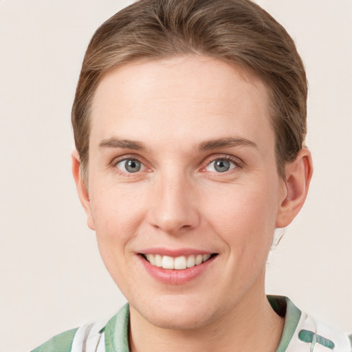 Joyful white young-adult female with short  brown hair and grey eyes