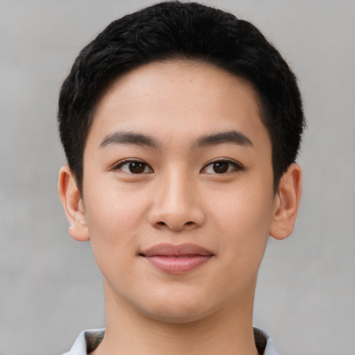 Joyful asian young-adult male with short  brown hair and brown eyes