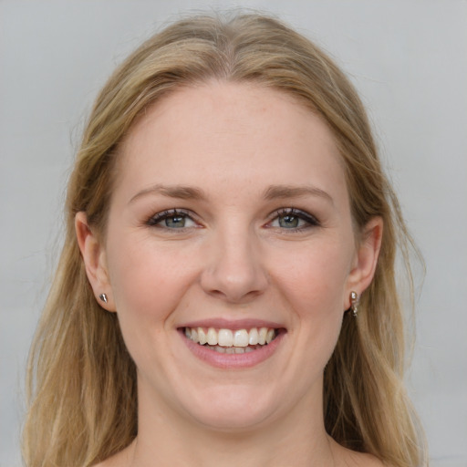 Joyful white young-adult female with medium  brown hair and blue eyes