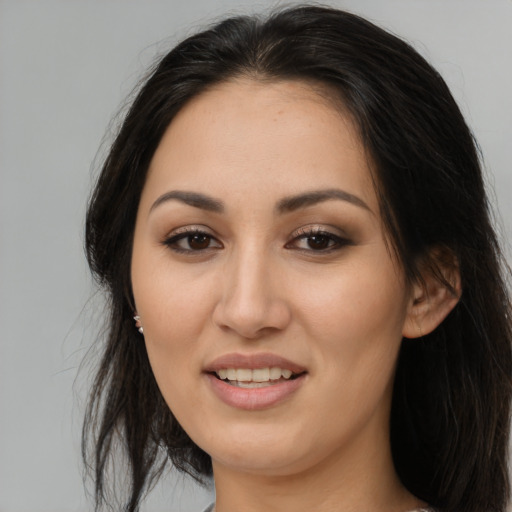 Joyful asian young-adult female with long  brown hair and brown eyes