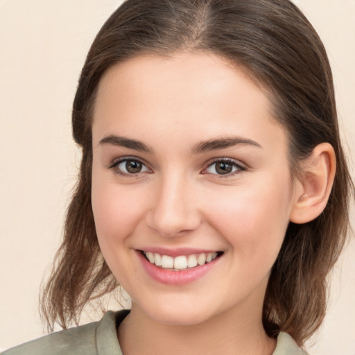 Joyful white young-adult female with medium  brown hair and brown eyes