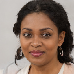 Joyful black young-adult female with medium  brown hair and brown eyes