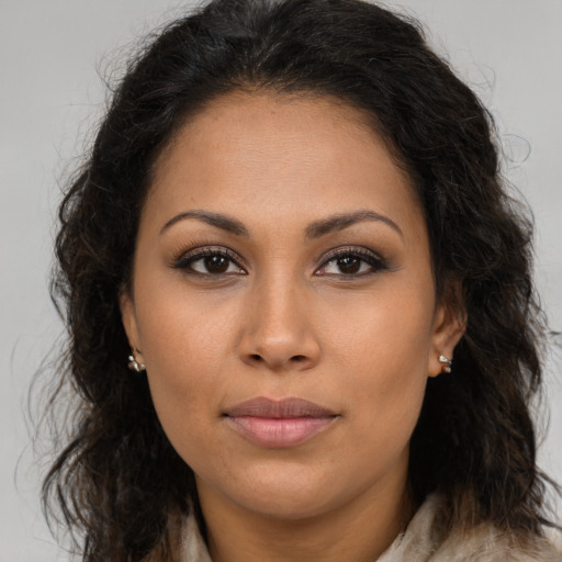 Joyful latino young-adult female with long  brown hair and brown eyes