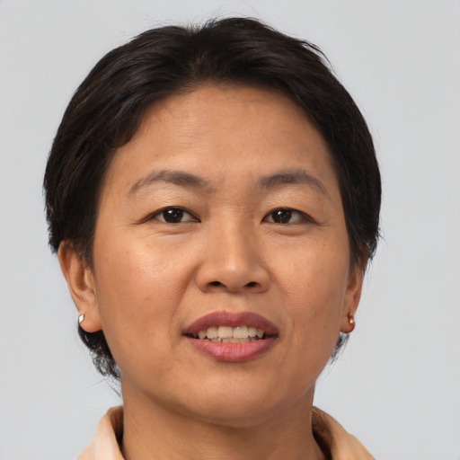 Joyful asian adult female with short  brown hair and brown eyes