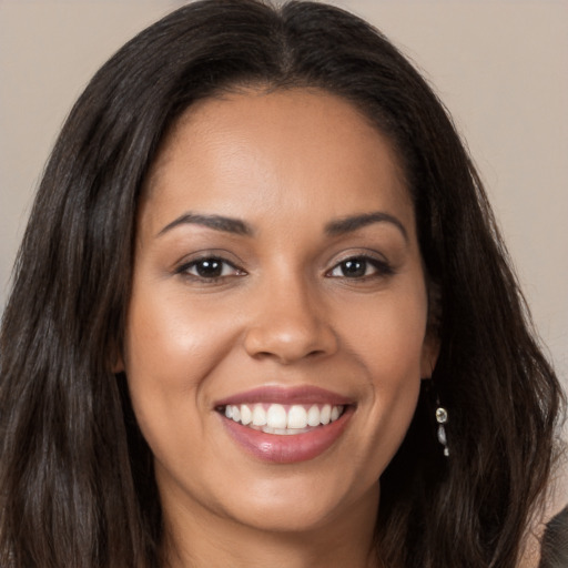 Joyful latino young-adult female with long  brown hair and brown eyes