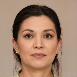 Joyful white adult female with medium  brown hair and brown eyes