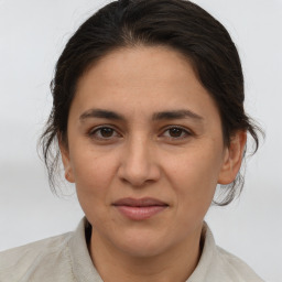 Joyful white adult female with medium  brown hair and brown eyes