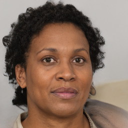 Joyful black adult female with short  brown hair and brown eyes