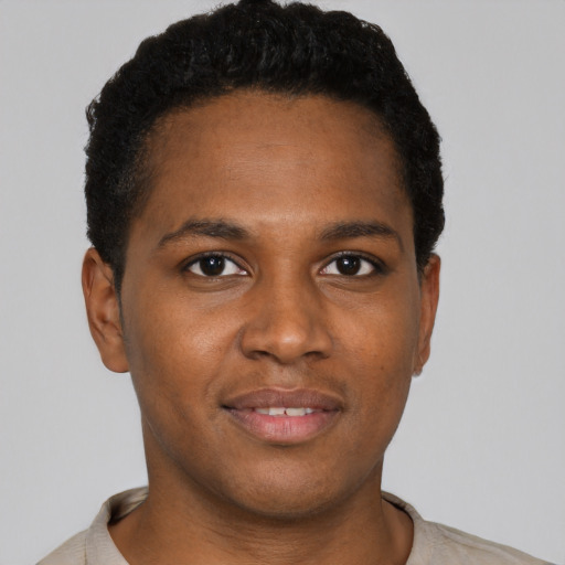 Joyful black young-adult male with short  brown hair and brown eyes