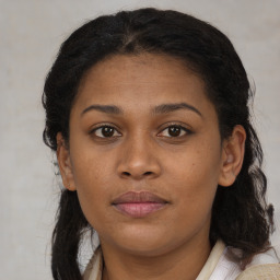 Joyful black young-adult female with medium  brown hair and brown eyes