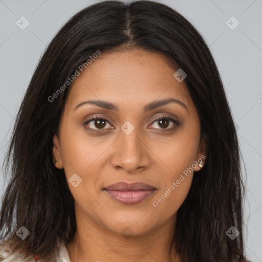 Joyful latino young-adult female with long  brown hair and brown eyes