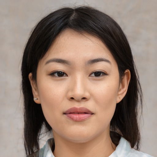 Joyful asian young-adult female with medium  black hair and brown eyes