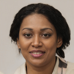 Joyful black adult female with medium  brown hair and brown eyes