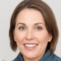 Joyful white adult female with medium  brown hair and grey eyes