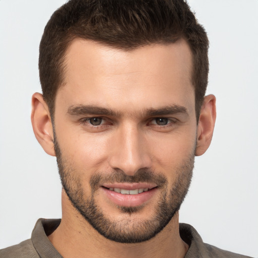 Joyful white young-adult male with short  brown hair and brown eyes