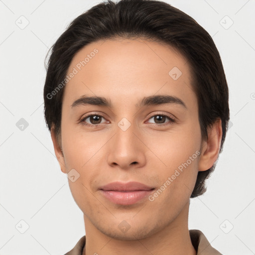 Joyful latino young-adult male with short  brown hair and brown eyes