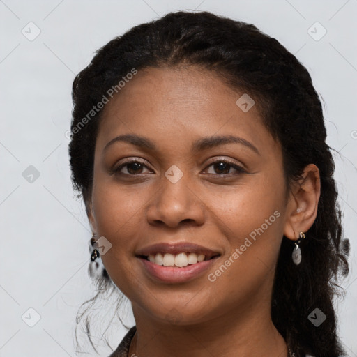 Joyful black young-adult female with long  black hair and brown eyes