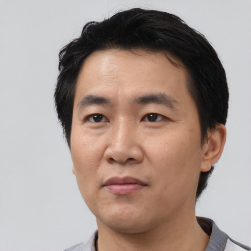 Neutral asian adult male with short  black hair and brown eyes