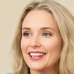 Joyful white young-adult female with long  brown hair and green eyes