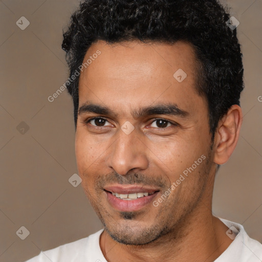 Joyful white young-adult male with short  black hair and brown eyes