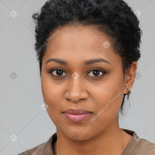 Joyful black young-adult female with long  brown hair and brown eyes