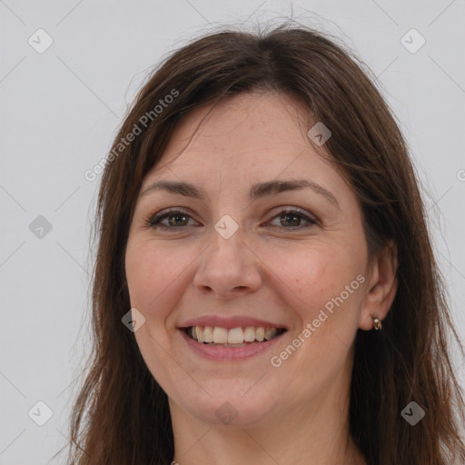 Joyful white adult female with long  brown hair and brown eyes