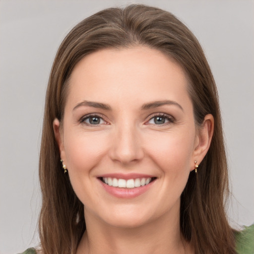 Joyful white young-adult female with long  brown hair and grey eyes