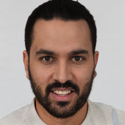 Joyful white young-adult male with short  black hair and brown eyes