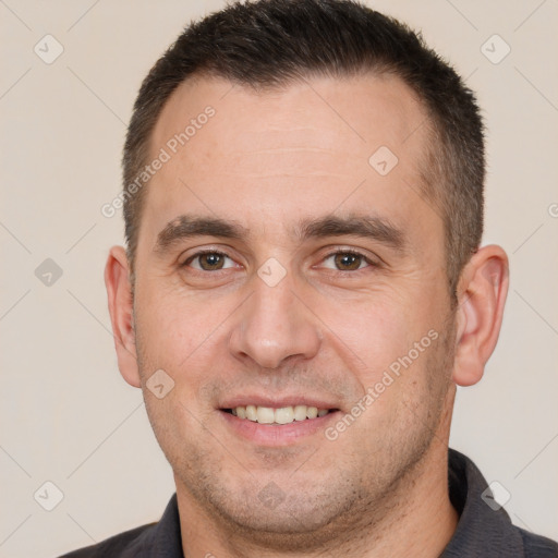 Joyful white adult male with short  brown hair and brown eyes