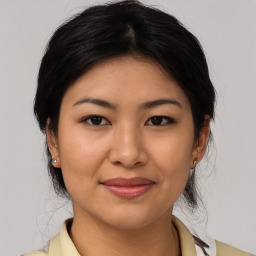 Joyful latino young-adult female with medium  brown hair and brown eyes