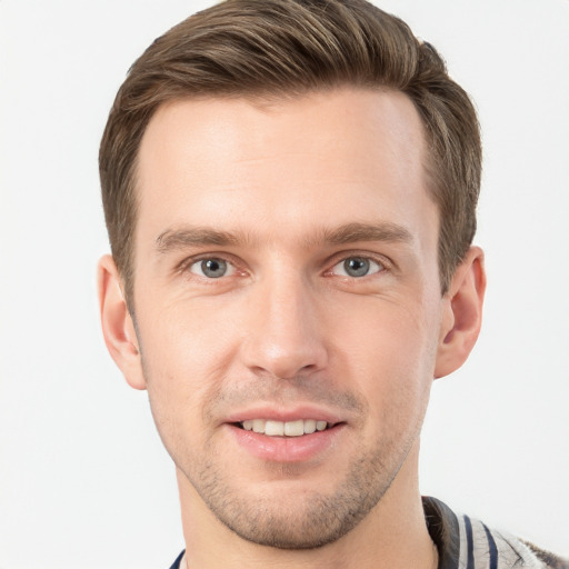 Joyful white young-adult male with short  brown hair and grey eyes