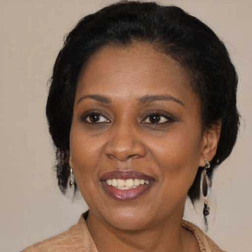 Joyful black adult female with medium  brown hair and brown eyes
