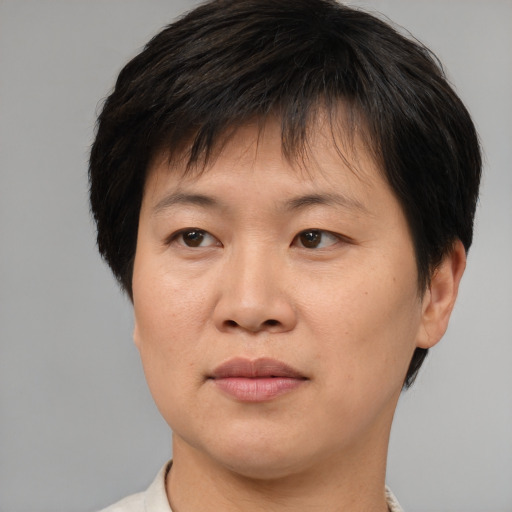 Joyful asian adult female with short  brown hair and brown eyes