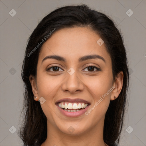 Joyful latino young-adult female with long  brown hair and brown eyes