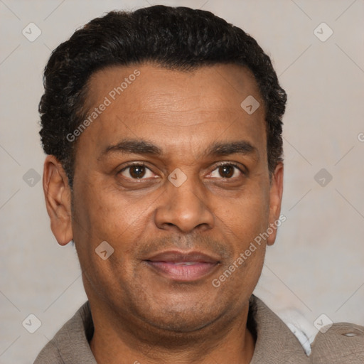 Joyful black adult male with short  black hair and brown eyes