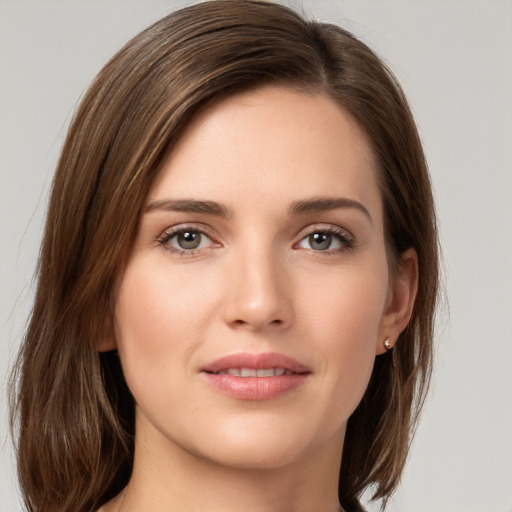 Joyful white young-adult female with medium  brown hair and grey eyes