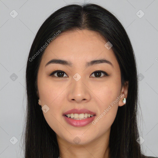 Joyful asian young-adult female with long  brown hair and brown eyes