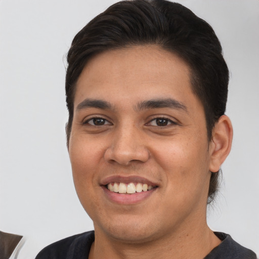 Joyful white young-adult male with short  black hair and brown eyes