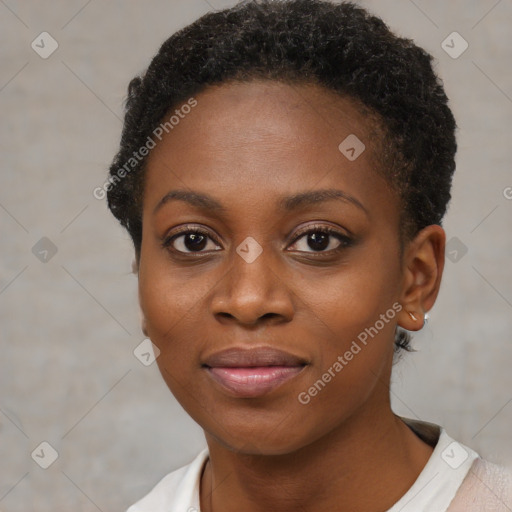 Joyful black young-adult female with short  brown hair and brown eyes