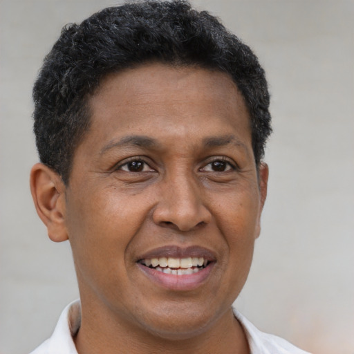 Joyful latino adult male with short  brown hair and brown eyes