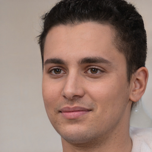 Joyful white young-adult male with short  brown hair and brown eyes