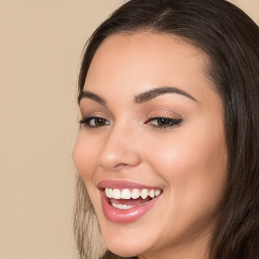 Joyful white young-adult female with long  brown hair and brown eyes